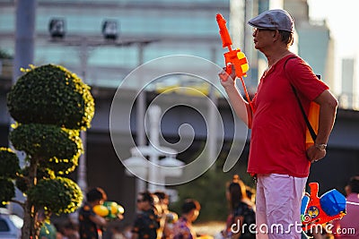 A man plays water during Songkran Editorial Stock Photo